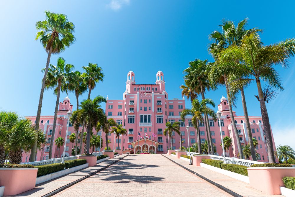 The light pink facade of the famous Don Cesar hotel in St. Pete, Florida, on a clear day.